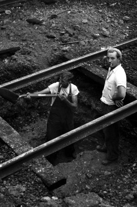 Workmen remove tram tracks on the Sydney Harbour Bridge on 30 June 1958. 