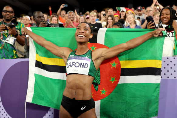 Thea LaFond of Dominica celebrates after winning gold in the women’s triple jump.