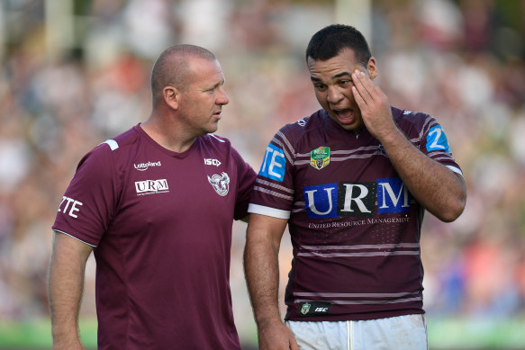 Lloyd Perrett of Manly is assisted from the field during a game in 2017.