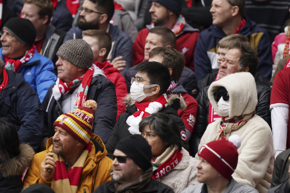 Fans wearing face masks attend a Liverpool match in the English Premier League.
