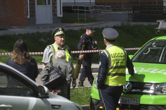 Police officers guard an area where a Ukrainian drone damaged an apartment building in Moscow on Tuesday.