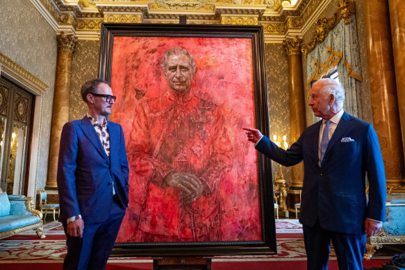 Artist Jonathan Yeo and King Charles III stand in front of the portrait of the King Charles III by artist Jonathan Yeo as it is unveiled in the blue drawing room at Buckingham Palace in London, England. 
