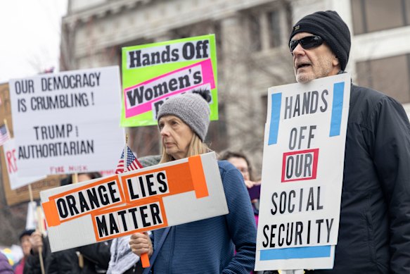 John Vesey listens to speakers during a Hands Off! rally at Rosa Parks Circle in Grand Rapids, Michigan.