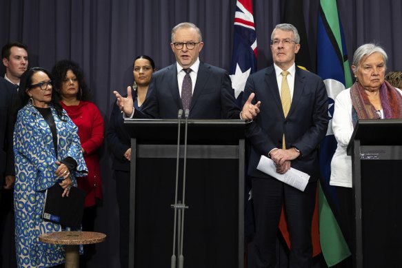 Prime Minister Anthony Albanese, flanked by ministers and Voice advocates, as he welcomed the passage of the Voice referendum bill through the parliament on Monday. 
