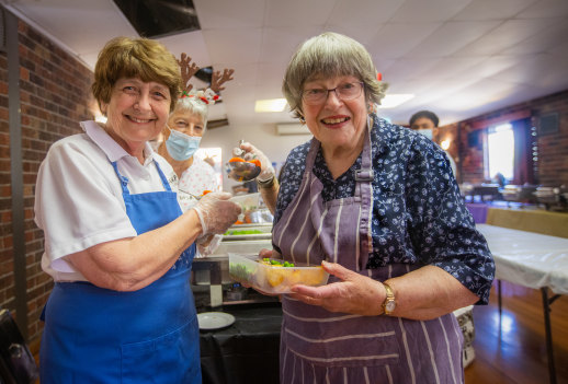 Happy to help: Good friends Veronica Blair, left, and Gwen Fitzgerald spent Christmas Day volunteering at St Anthony’s Catholic Church free lunch service.