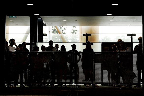 Commuters wait for ferries at the Manly Wharf.