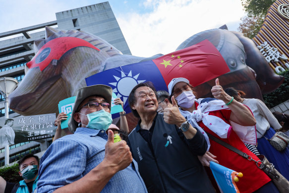 DPP party member Wang Shih-Cheng in front of an inflatable Trojan Horse. 