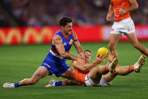 Tom Liberatore of the Bulldogs tackles Toby Greene in a game back in March.