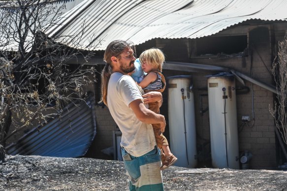Bela Pechnig with his child Rhaya. They lost their family home and livelihood when fire ripped through the town of Pomonal in north-western Victoria.