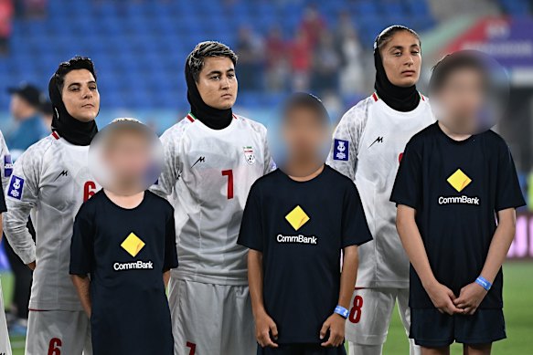 Iran players stand silently during their national anthem before their match against South Korea on March 2.