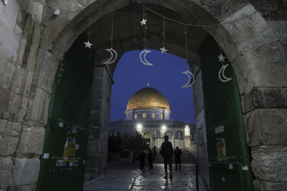 Muslims walk next to the Dome of Rock Mosque at the Al-Aqsa Mosque compound in Jerusalem’s Old City on Sunday.