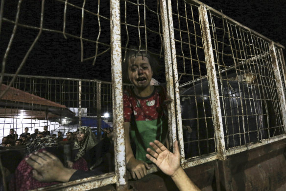 A wounded Palestinian boy arrives at the al-Shifa hospital, on a truck, following Israeli airstrikes.