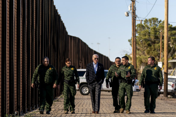 President Joe Biden talks with  Border Patrol agents as they walk along a stretch of the US-Mexico border in El Paso, Texas, in 2023.