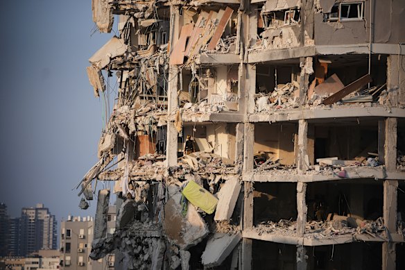 Israeli security forces inspect a destroyed building that was hit by a missile fired from Iran.
