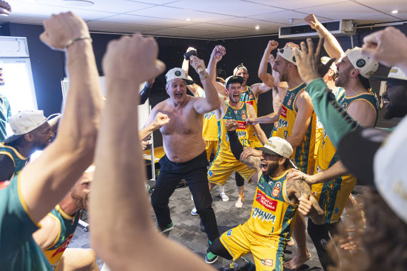 Celebrations for the Tasmania JackJumpers NBL title win hit full stride, with shirtless coach Scott Roth leading the way.
