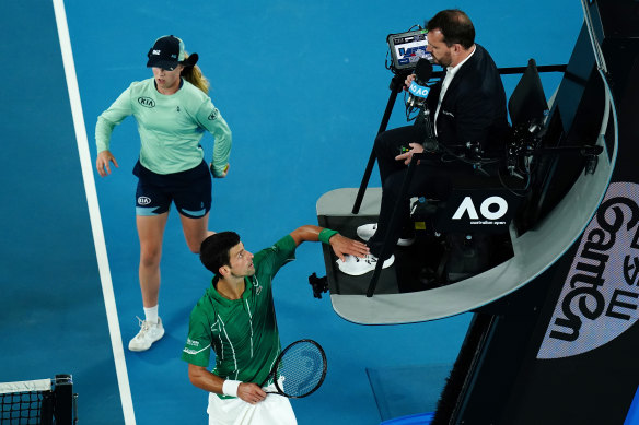 Novak Djokovic taps the chair umpire's foot during the Australian Open final.