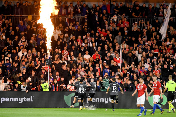 Teammates mob Al Hassan Toure after his penalty.