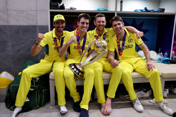 Mitchell Starc, Pat Cummins, Josh Hazlewood and Mitch Marsh of Australia pose with the World Cup trophy.