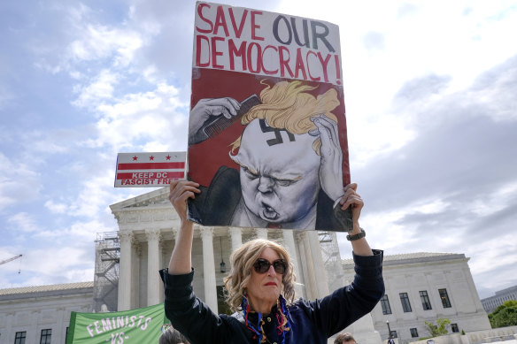 A protester outside the Supreme Court in April as the justices heard arguments over whether Donald Trump is immune from prosecution.