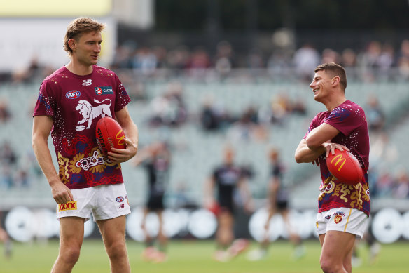 Harris Andrews and Dayne Zorko of the Lions warm up.