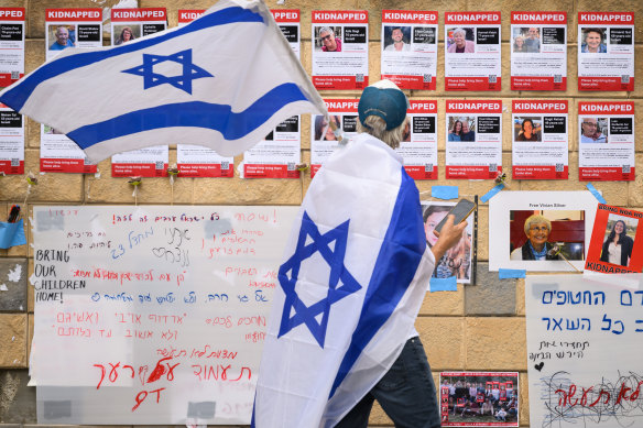 Photographs of some of those taken hostage by Hamas are posted on a wall in Tel Aviv.