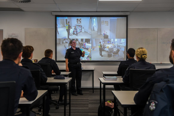 Family violence. Police take lessons from the classroom, here observing a live feed from a simulated house, to the street.
