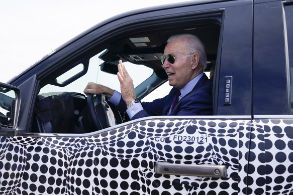 Joe Biden test-driving  a Ford F-150 Lightning EV last year. His EV strategy includes sourcing minerals from Australia.