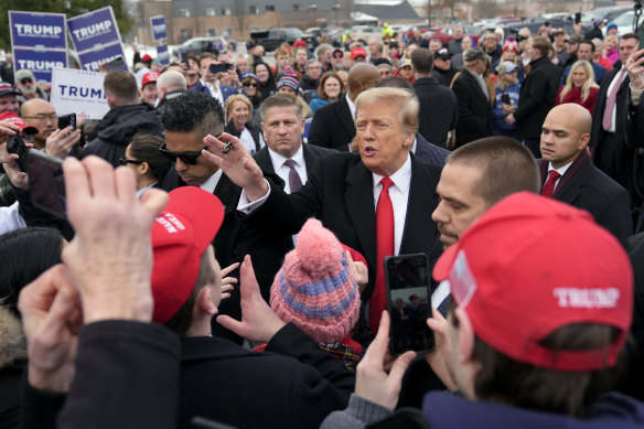 Republican presidential candidate former President Donald Trump gestures to supporters as he arrives at a campaign stop in Londonderry, New Hampshire.