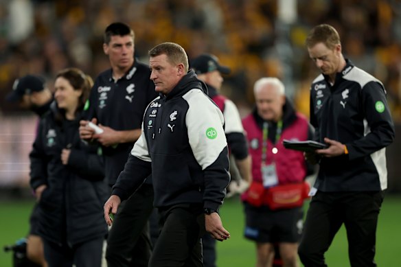 Blues coach Michael Voss walks off the ground.