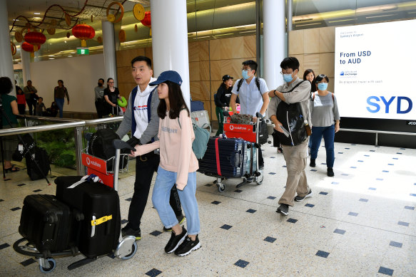 Passengers wearing protective masks arriving in Australia over the weekend.