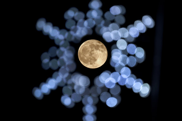 The rising moon, framed by Christmas lights in southern Missouri in the US on November 30.