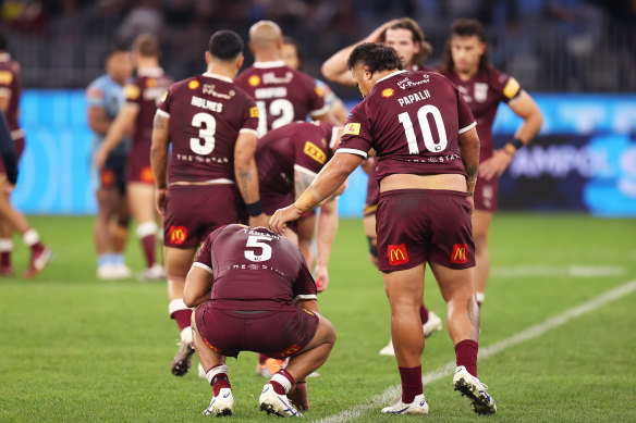 A dejected Selwyn Cobbo is comforted by Queensland teammate Josh Papalii.