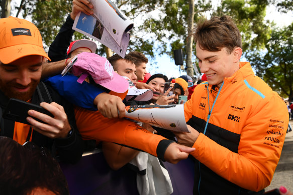 Oscar Piastri greets fans at Albert Park during the Australian Grand Prix.