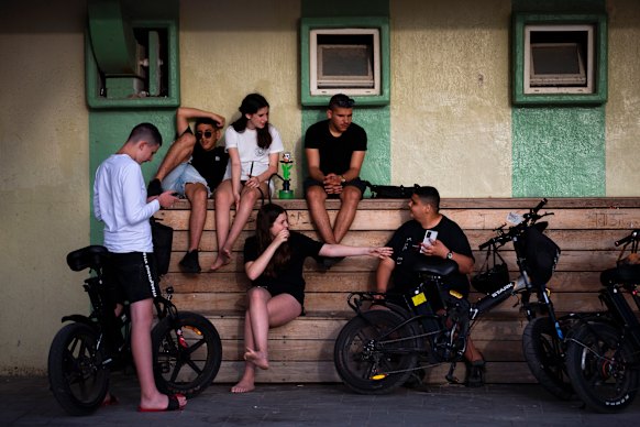 Israeli youths without face masks enjoy a sunny day at Tel Aviv’s beach, Israel, on Sunday, April 18.