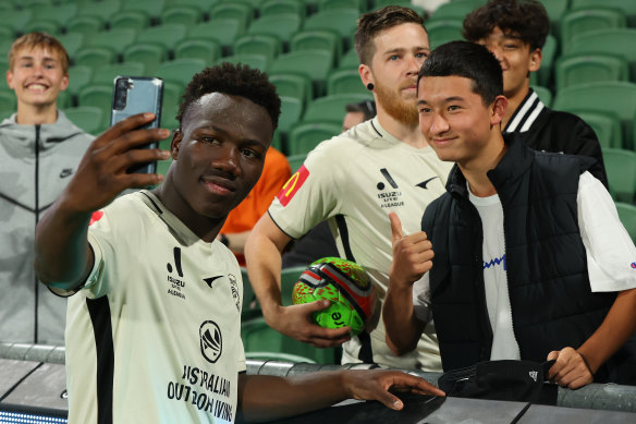 Irankunda taking selfies with Adelaide fans.