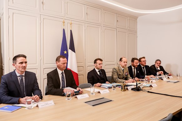 French President Emmanuel Macron, centre, attends a video conference with British Prime Minister Keir Starmer, on Thursday.