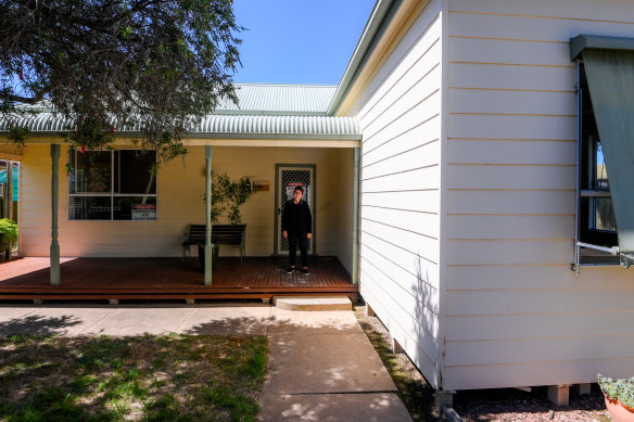 Glenys Mulcahy outside her house. 