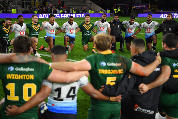 Fiji and Australia join together in a post-match prayer circle after the Kangaroos’ 34-point win in Leeds.