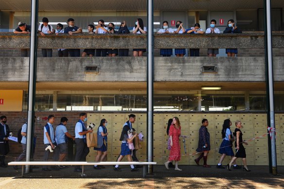 Year 12 students at Canley Vale are cheered by younger students.