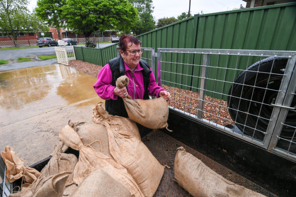 Joyce Cocoran sandbagging a friend’s home as Rochester residents prepare for a Campaspe River flood.