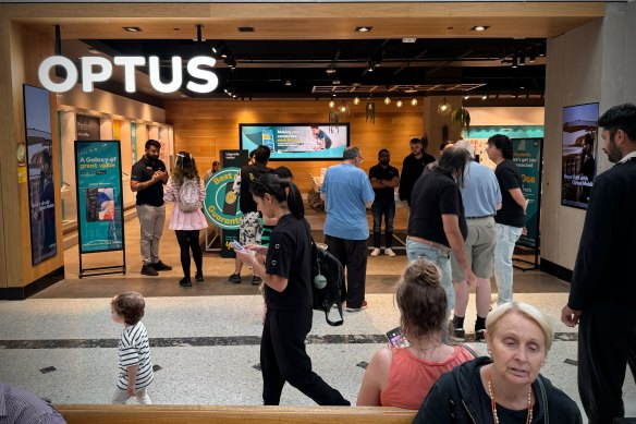 Customers at the Westfield Penrith  Optus store during the outage on Wednesday.