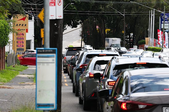 Cars queue for petrol in Sydney as some people panic-buy due to fears of shortages or price increases.