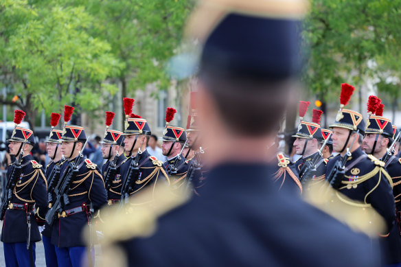 French military begin to gather at the Arc de Triomphe ahead of a ceremonial welcome for King Charles III in Paris.