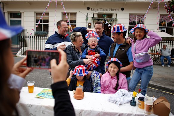 People pose for a photo during a public street party in central London over the long weekend.