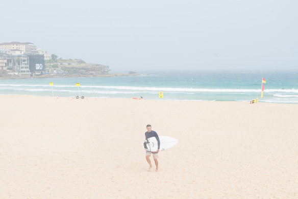 A swimmer braves the weather at Bondi Beach on Sunday.