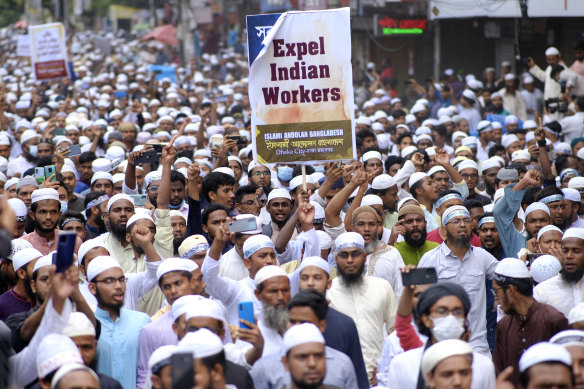 Muslims hold placards and shout slogans against Nupur Sharma, a spokesperson of India’s governing Hindu nationalist party as they react to the derogatory references to Islam and the Prophet Muhammad made by her, during a protest in Dhaka, Bangladesh, on Friday, June 10.
