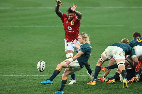 Faf De Klerk of the Springboks kicks past Courtney Lawes.