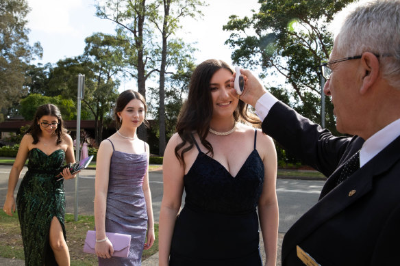Everybody has their temperature taken before entering Curzon Hall for the St George Girls High School formal.