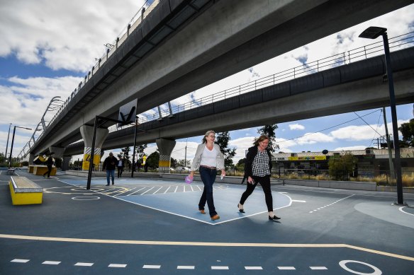The minister for the Suburban Rail Loop, Jacinta Allan (left), under the elevated rail near Clayton Station.