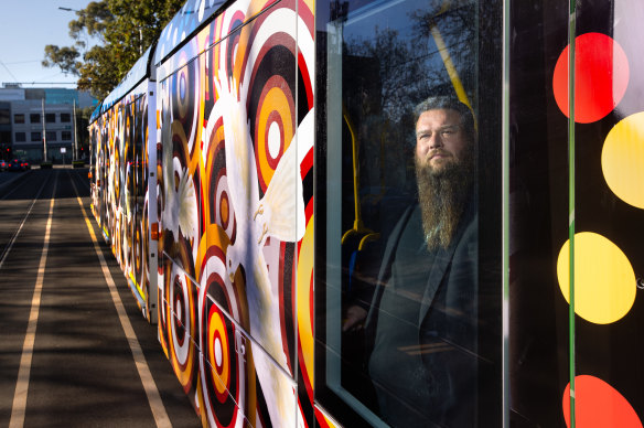 Tiriki Onus inside the new art tram reproducing his father’s 1991 original work.